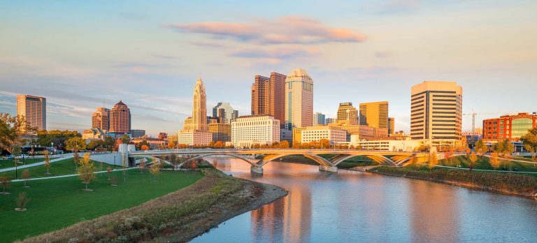 The City of Columbus Skyline with River and Mini Bernedoodle Dog Park along with downtown skyscrapers.