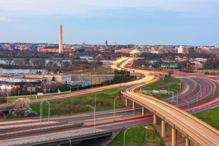 Washington DC, USA cityscape and highways at dusk.