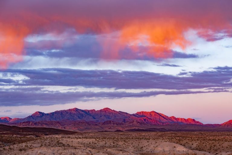 Orange sunset clouds over barren arid mountain desert landscape near Lake Mead by Las Vegas, Nevada, NV, US America, USA
